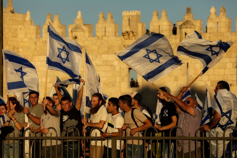 Jewish ultranationalists wave Israeli flags during the “Flags March” next to Damascus gate, outside Jerusalem’s Old City, in 2021.