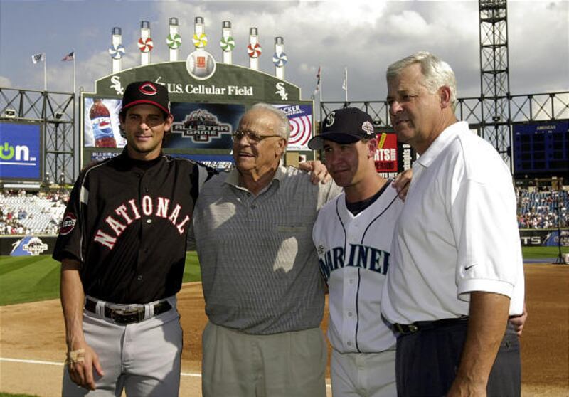 Then-Cincinnati Reds' players Aaron Boone, left, and his brother, Bret, second from right, pose with their grandfather, Ray, second from left, and father, Bob, right, before the 74th Major League Baseball All-Star Game at U.S. Cellular Field in Chicago in