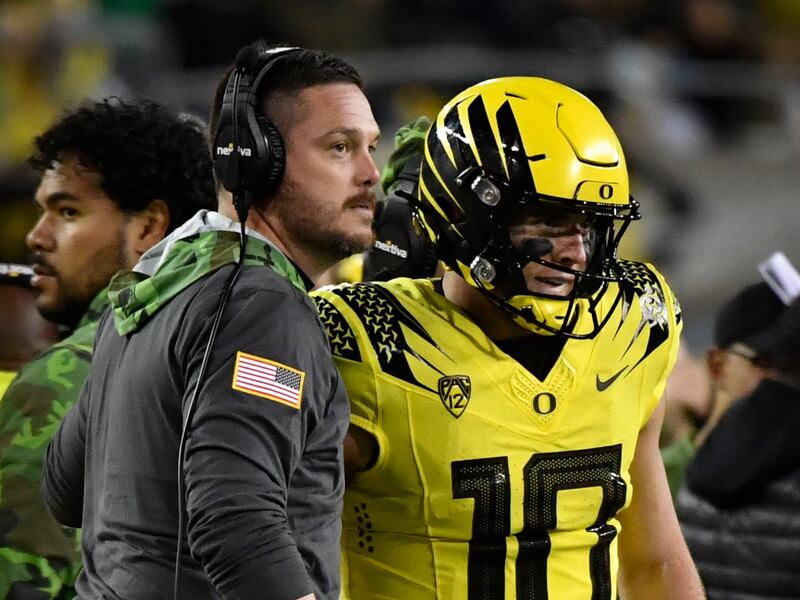 Oregon coach Dan Lanning and quarterback Bo Nix celebrate a TD against Washington during game, Nov. 12, 2022, in Eugene.