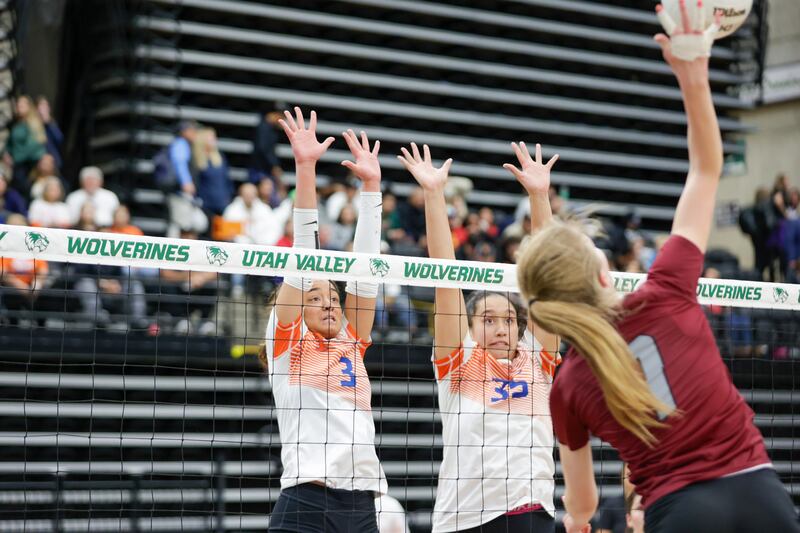 Timpview Thunderbirds’ Silina Damuni (wearing white), left, jumps to block a shot from the Northridge Knights