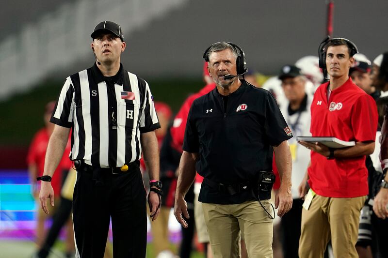 Utah head coach Kyle Whittingham stands next to a referee during game against Southern California Saturday, Oct. 9, 2021, in Los Angeles.