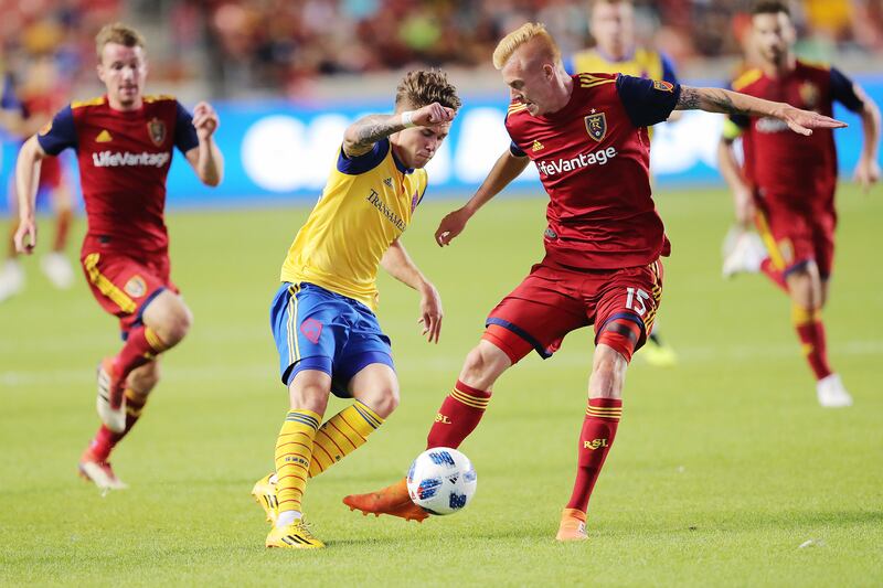 Real Salt Lake defender Justen Glad (15) defends Colorado Rapids midfielder Sam Nicholson (28) as Real Salt Lake and the Colorado Rapids play at Rio Tinto Stadium in Sandy on Saturday, July 21, 2018.
