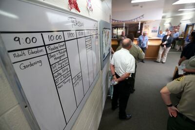 Kristen Cox, executive director of the Governor's Office of Management and Budget, and Dallas Earnshaw, Utah State Hospital superintendent, center, lead a tour of the Inpatient Forensic Restoration Unit at the Provo hospital on Thursday, July 19, 2018.