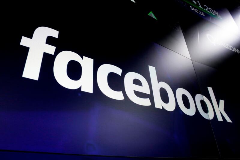 This March 29, 2018, file photo shows the Facebook logo on screens at the Nasdaq MarketSite in New York’s Times Square. Facebook on Tuesday, April 28, 2020, reported its slowest quarterly growth as a public company, pressured by a global slowdown in the digital advertising market due to the coronavirus pandemic.