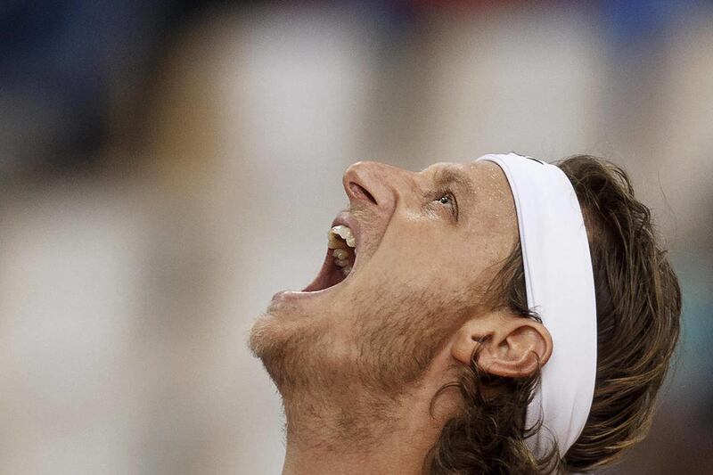 Argentina's David Nalbandian shouts while playing with team mate Eduardo Schwank, not seen, in a doubles tennis match of the Davis Cup Final, against Spain's Fernando Verdasco and Feliciano Lopez, in Seville, Spain, Saturday, Dec. 3, 2011.