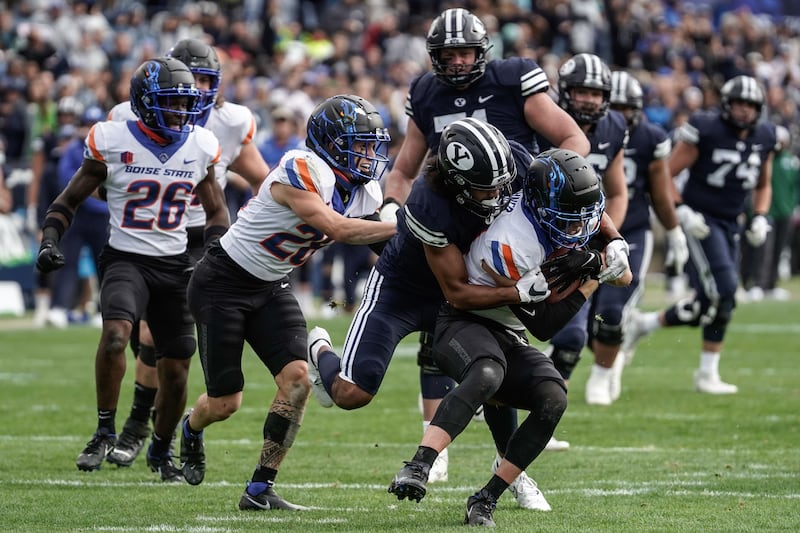 Boise State safety Alexander Teubner, right, gets tackled by BYU wide receiver Keanu Hill during an NCAA college football game at LaVell Edwards Stadium in Provo on Saturday, Oct. 9, 2021.