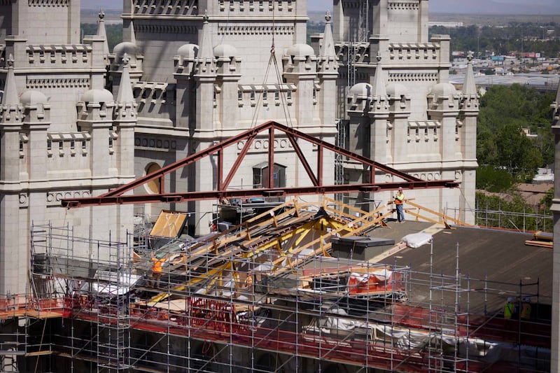 Crew members install a new steel truss to help strengthen the seismic design of the Salt Lake Utah Temple.