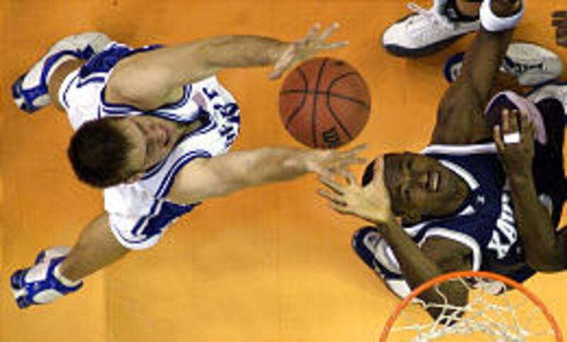 Duke's Shavlik Randolph, left, goes up for a rebound over Xavier's Ramain Sato Sunday.