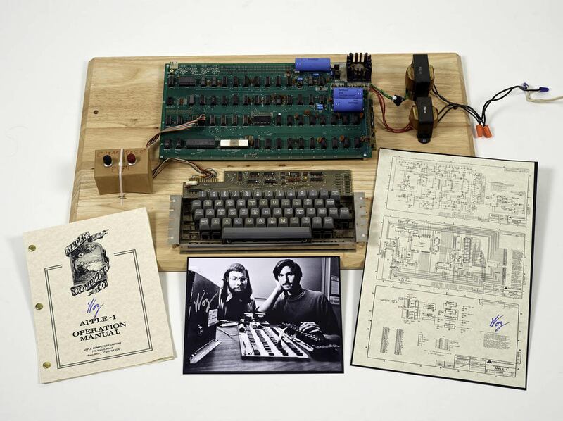 This undated photo provided by Christie’s Auction House shows an “Apple 1” prototype computer, built in 1976, accompanied by an operation manual and schematic as well as a photo of its inventors, Steve Wozniak, left, and Steve Jobs. One of the very first