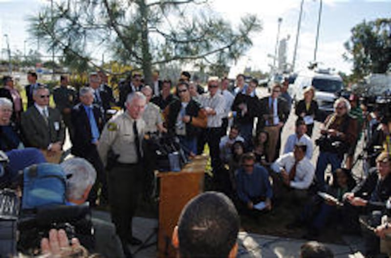 Santa Barbara County Sheriff Jim Anderson answers questions after a deadly shooting spree at a postal facility in Goleta, Calif.