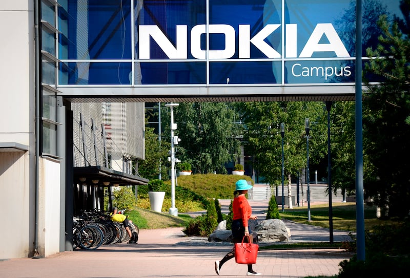 In this July 26, 2018 file photo, a woman walks at the headquarters of Finnish telecommunication network company Nokia in Espoo, Finland.