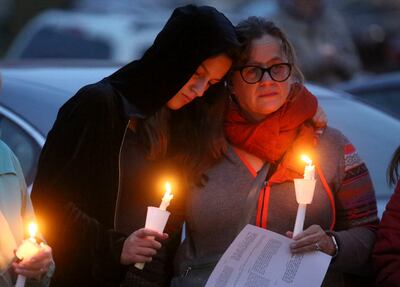 Lucy Zavitz and her mother Suzanne Attix attend a vigil and prayer service for all those impacted by the shooting at the Tree of Life Synagogue in Pittsburgh, outside of Chabad Lubavitch of Utah in Salt Lake City on Monday, Oct. 29, 2018.