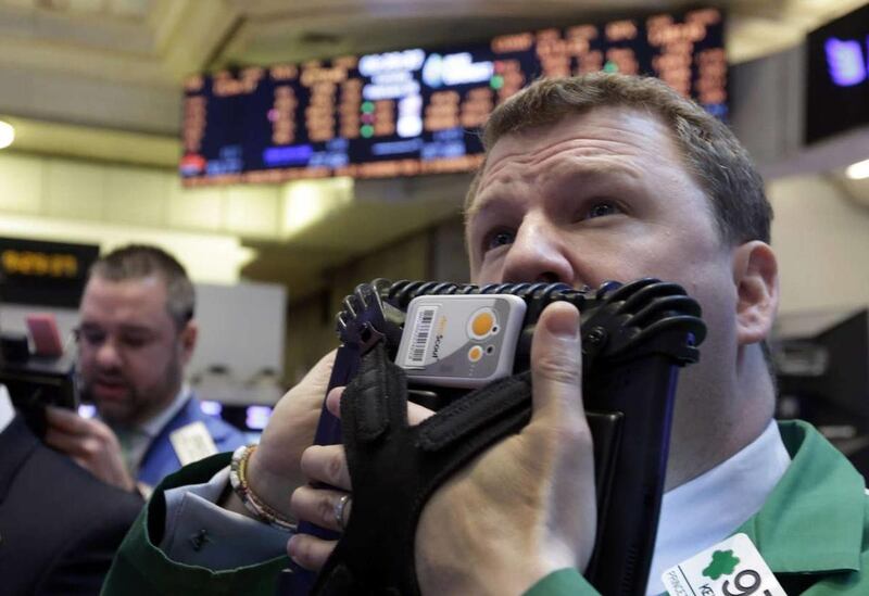 Trader Kevin Coulter, right, works on the floor of the New York Stock Exchange Tuesday, Feb. 26, 2013.