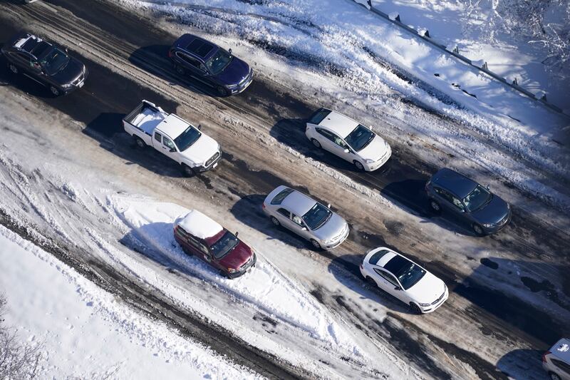 Traffic slowly moves around a stranded car on a section of Interstate 95.
