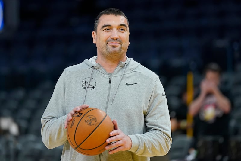 Golden State Warriors assistant coach Dejan Milojevic holds a ball before a preseason game between the Golden State Warriors.