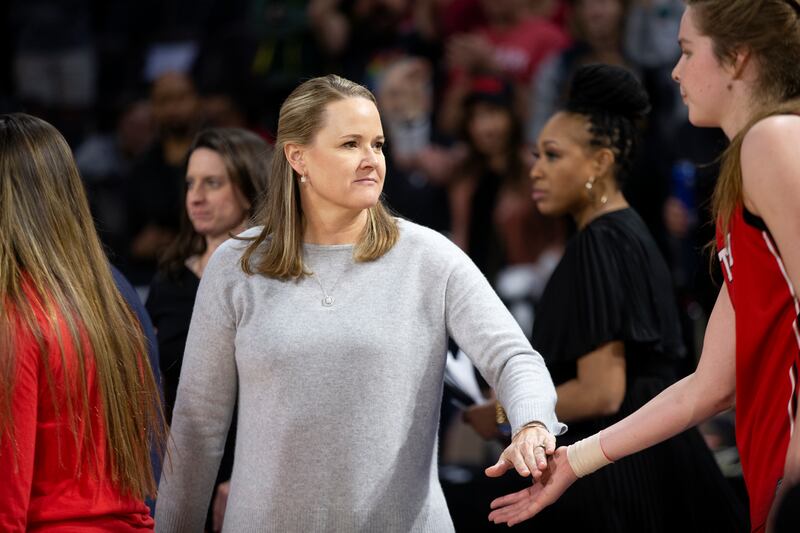Utah coach Lynne Roberts slaps hands with Utah’s Kelsey Rees after their team lost fell to Stanford in Pac-12 tournament.