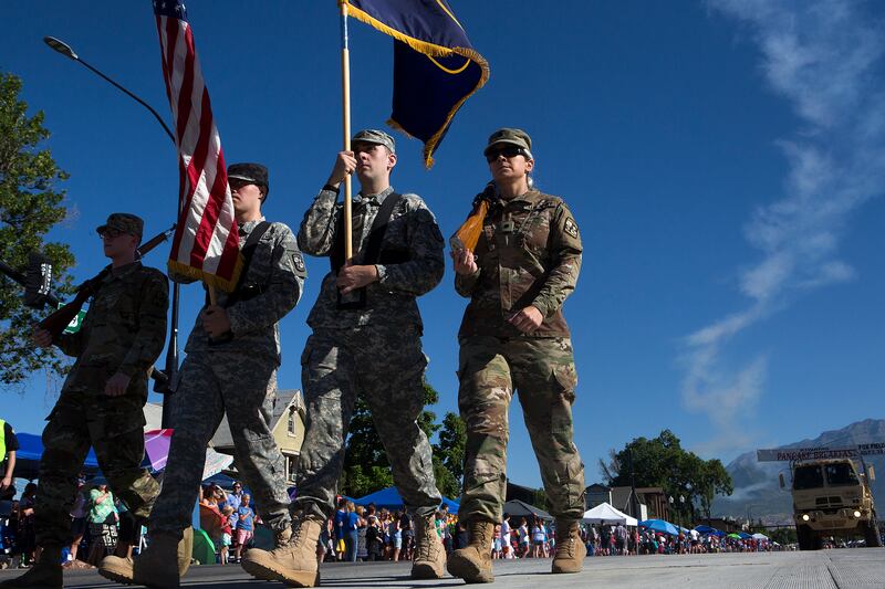 Army soldiers march the US and Utah flags down the street during the Freedom Festival’s July 4th Grand Parade in Provo on Wednesday, July 4, 2018.