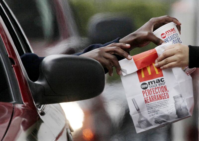 In this Jan. 22, 2010, file photo, a customer grabs lunch at a McDonalds drive-thru in Chicago.