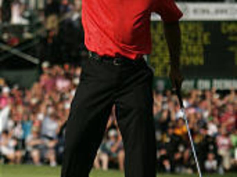 Tiger Woods celebrates winning the Buick Open in Grand Blanc, Mich. It was his fourth win in 2006.