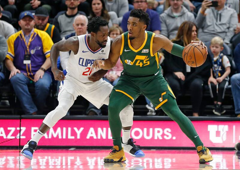 Los Angeles Clippers guard Patrick Beverley (21) guards Utah Jazz guard Donovan Mitchell (45) in the first half during an NBA basketball game Wednesday, Feb. 27, 2019, in Salt Lake City. (AP Photo/Rick Bowmer)