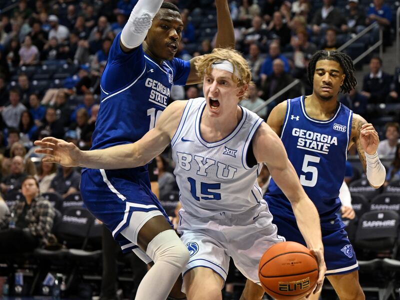 Brigham Young Cougars guard Richie Saunders (15) drives around Georgia State Panthers forward Jay’Den Turner (10) as BYU and Georgia State play at the Marriott Center in Provo on Saturday, Dec. 16, 2023. BYU won 86-54.