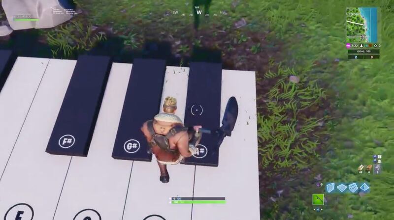 Players hit piano keys to end up playing the songs "Jingle Bells" and "The Twelve Days of Christmas."