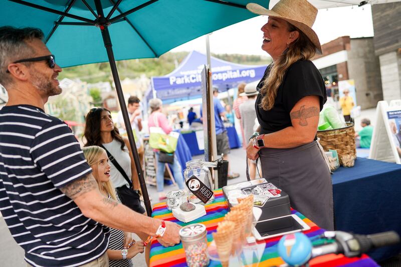 Kris May, owner of Wasatch Creamery Ice Cream Company, right, serves T.J. Stevenson, Esmé Stevenson and Jessica Privett, left to right, of Salt Lake City, at the Kimball Arts Festival in Park City on Saturday, Aug. 3, 2019.