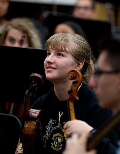 Aubrey Henrie listens to Thierry Fischer, music director of the Utah Symphony, during practice with the Cottonwood High School orchestra in Murray on Thursday, March 14, 2019. High school orchestras across the state are rehearsing the same piece and will