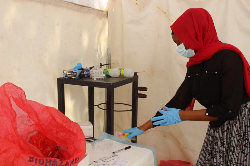 A nurse prepares to test a person for COVID-19 in Nigeria.