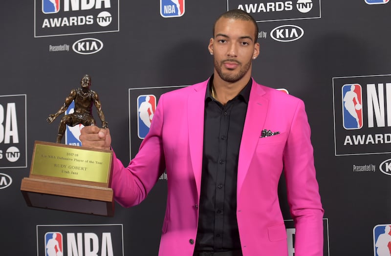 Rudy Gobert shows off his NBA Defensive Player of the Year trophy.