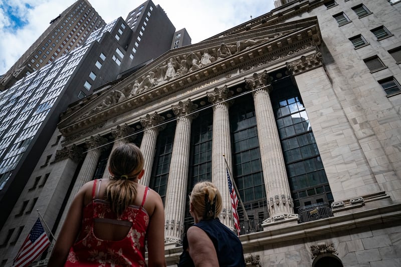 Pedestrians are pictured outside the New York Stock Exchange.