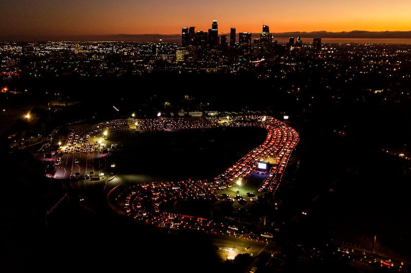In this Nov 18, 2020, file photo, motorists wait in long lines to take a coronavirus test in a parking lot at Dodger Stadium in Los Angeles. With coronavirus cases surging and families hoping to gather safely for Thanksgiving, long lines to get tested have reappeared across the U.S.