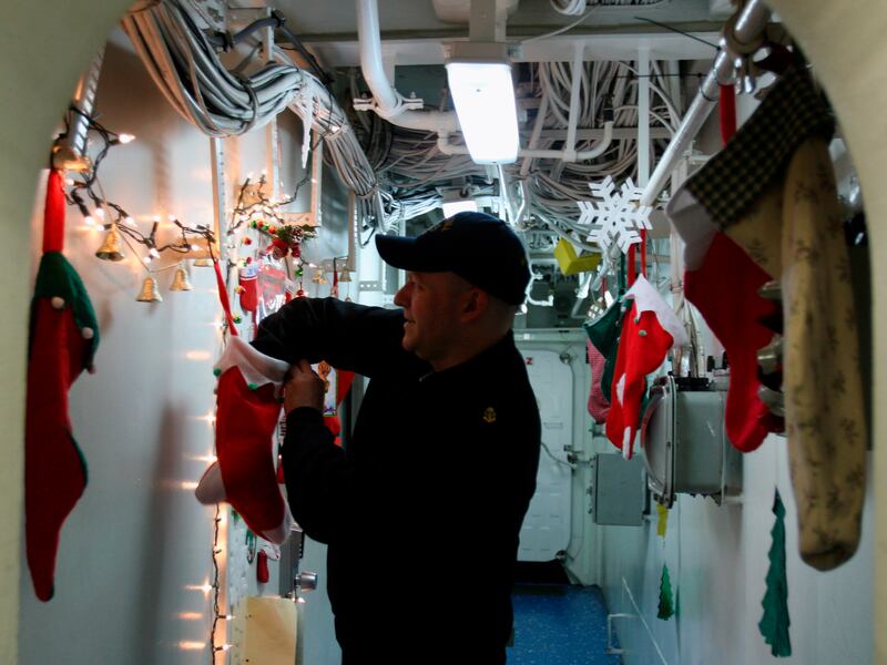 U.S. Navy Chief Petty Officer Scott Boyle, 36, of Suffolk, Virginia, reaches into a Christmas stocking, Dec. 23, 2008.