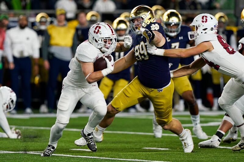 Stanford running back Casey Filkins (2) runs with the ball during the first half of an NCAA college football game against Notre Dame.
