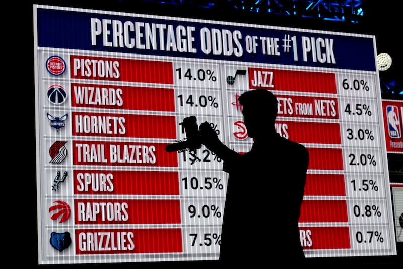NBA basketball draft prospect Kyle Filipowski takes video by himself in front of the draft lottery order before the draft lottery in Chicago, Sunday, May 12, 2024.