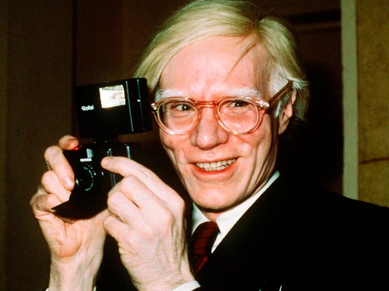 Pop artist Andy Warhol smiles in New York.