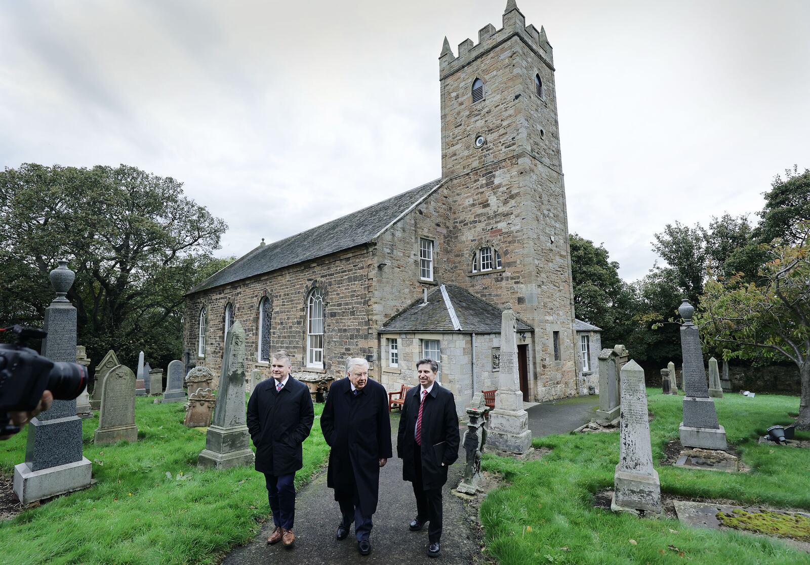 President M. Russell Ballard of The Church of Jesus Christ of Latter-day Saints, center, his son Craig Ballard, left, and Elder Massimo De Feo, Area President