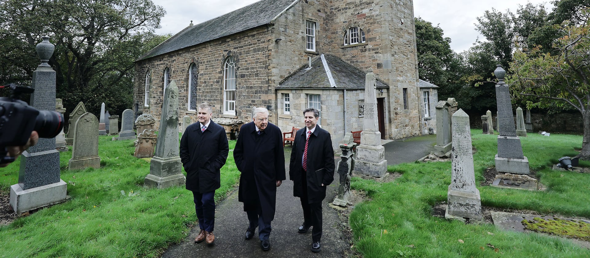 President M. Russell Ballard of The Church of Jesus Christ of Latter-day Saints, center, his son Craig Ballard, left, and Elder Massimo De Feo, Area President