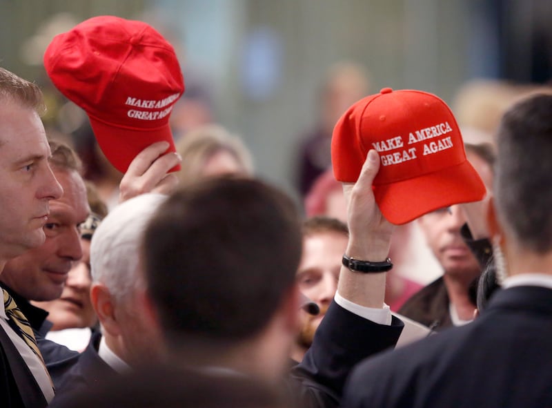 Members in the audience hold up "Make America Great Again" hats at the conclusion of a speech by Vice President Mike Pence at the America First Policies, "Tax Cuts to Put America First" event Thursday, March 22, 2018, in Manchester, N.H. (AP Photo/Mary Sc