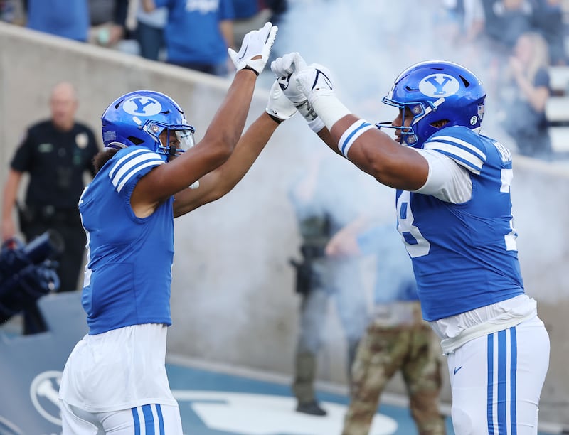 BYU wide receiver Keanu Hill celebrates his touchdown against Utah State with offensive lineman Kingsley Suamataia in Provo on, Sept. 29, 2022.