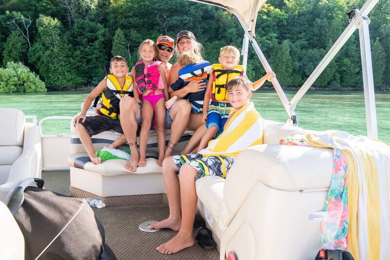 Josh and Erica Hartwig with their five kids. The Boca Raton couple are close to her ex-husband's family, often taking vacations together.