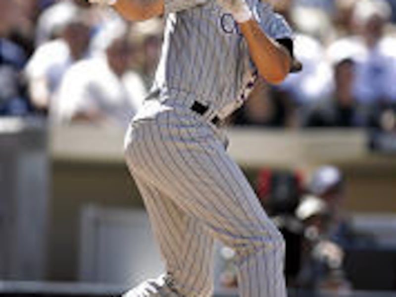 Colorado's Jason Smith watches the flight of his 2-run home run in the 5th inning against Padres.