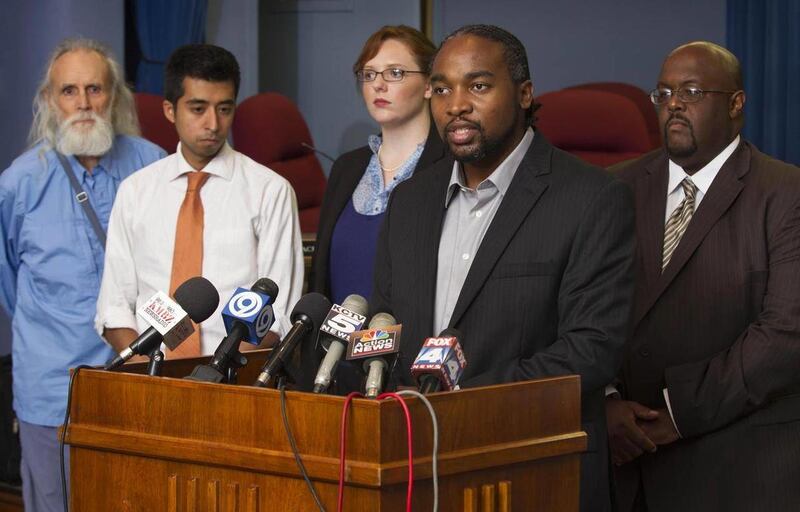 Kansas City School Board president Airick Leonard West, second from right, announced that the school board is trying to work out a solution for the sudden resignation of superintendent John Covington, Thursday, Aug. 25, 2011 in Kansas City, Mo.