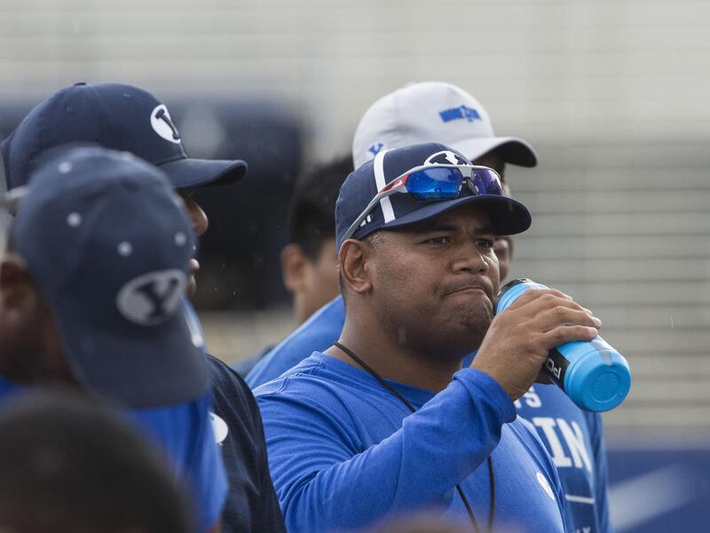 BYU defensive coordinator Ilaisa Tuiaki listens to the after practice debriefing in Provo on Thursday, Aug. 10, 2017.