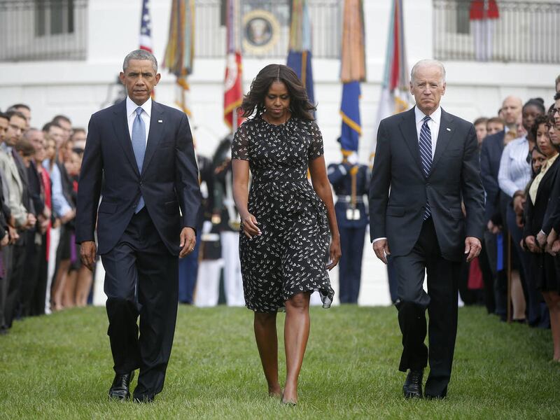 President Barack Obama, first lady Michelle Obama and Vice President Joe Biden walk on the South Lawn of the White House in Washington, Thursday, Sept. 11, 2014, to observe a moment of silence to mark the 13th anniversary of the 9/11 attack.
