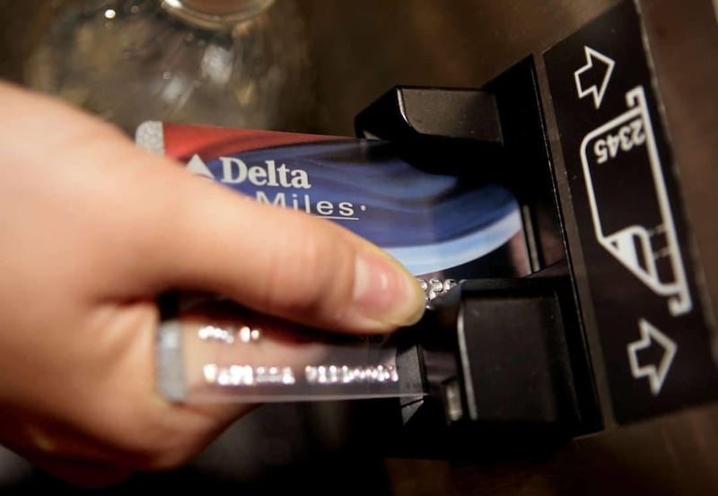 In this file photo, a traveler uses a Delta Air Lines credit card to buy an e-ticket at the Bob Hope Airport in Burbank, Calif. A new survey has shown many travelers who accumulate rewards points don't know how many they have.