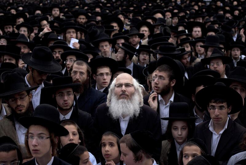 FILE - In this Monday, June 25, 2012 file photo ultra-Orthodox Jewish men participate in a prayer to protest an expected replacement to a Law, that exempts ultra-Orthodox yeshiva students from mandatory military service, in an ultra-Orthodox neighborhood