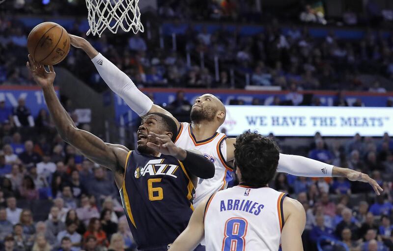 Utah Jazz forward Joe Johnson (6) goes up for a basket in front of Oklahoma City Thunder forward Taj Gibson, rear, during the second half of an NBA basketball game in Oklahoma City, Tuesday, Feb. 28, 2017. Oklahoma City won 109-106. (AP Photo/Alonzo Adams