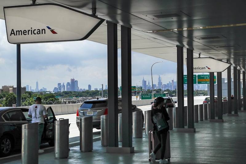 In this Wednesday, July 15, 2020, file photo, people arrive at the drop-off area of Terminal B at LaGuardia Airport in New York. Airlines are trying to convince a frightened public that measures like mandatory face masks and hospital-grade air filters make sitting in a plane safer than many other indoor settings during the coronavirus pandemic, but it isn’t working.