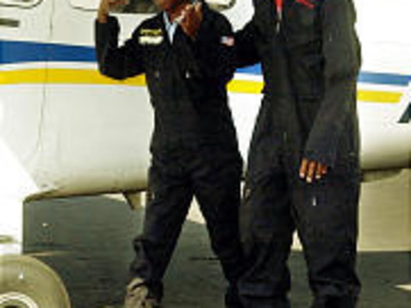 Jimmy Haywood, left, is the youngest black pilot to make an international flight, and Kenny Roy is the youngest licensed to fly solo.